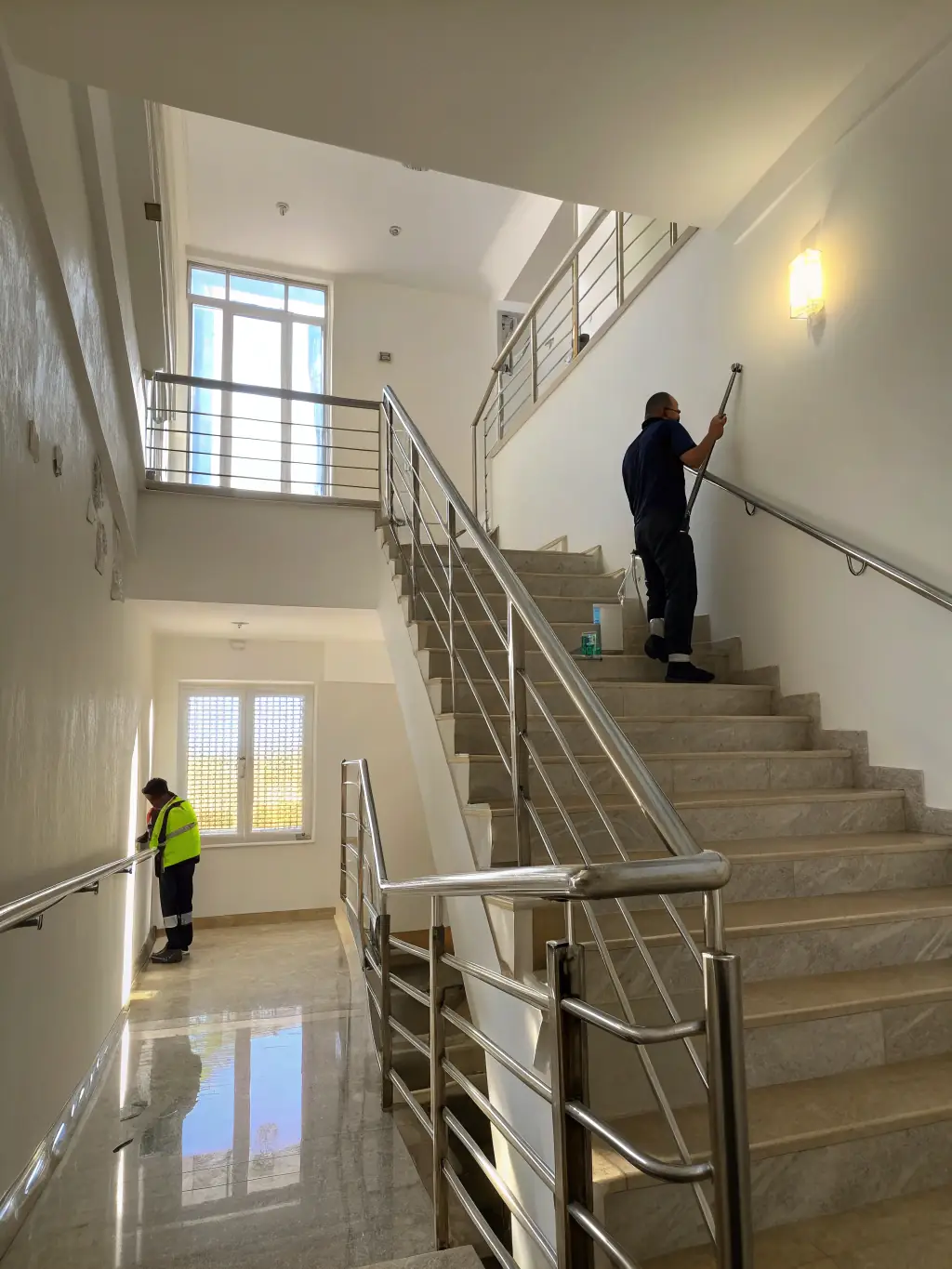 A clean and well-maintained stairwell in an apartment building, showcasing the attention to detail in FAKSCH's stairwell cleaning service.